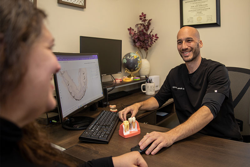 doctor going over dental procedure information with patient within the dental practice