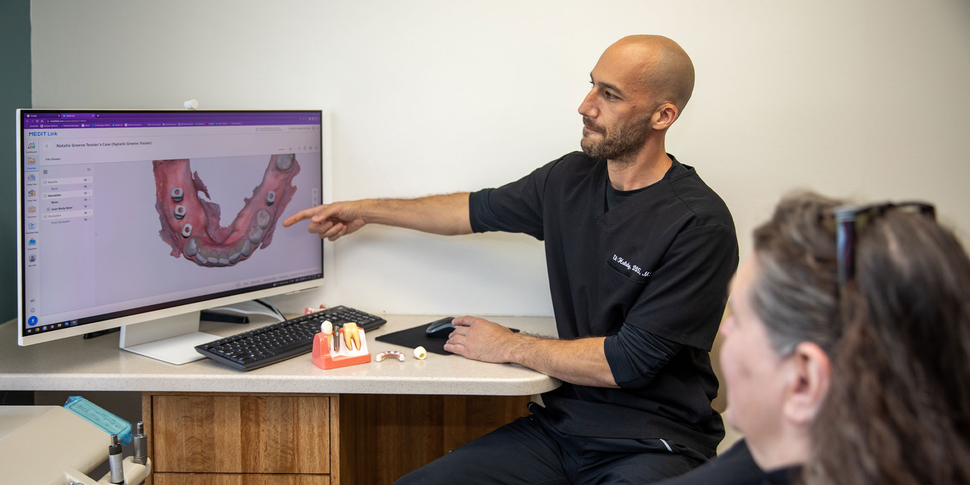 doctor going over dental procedure information with patient