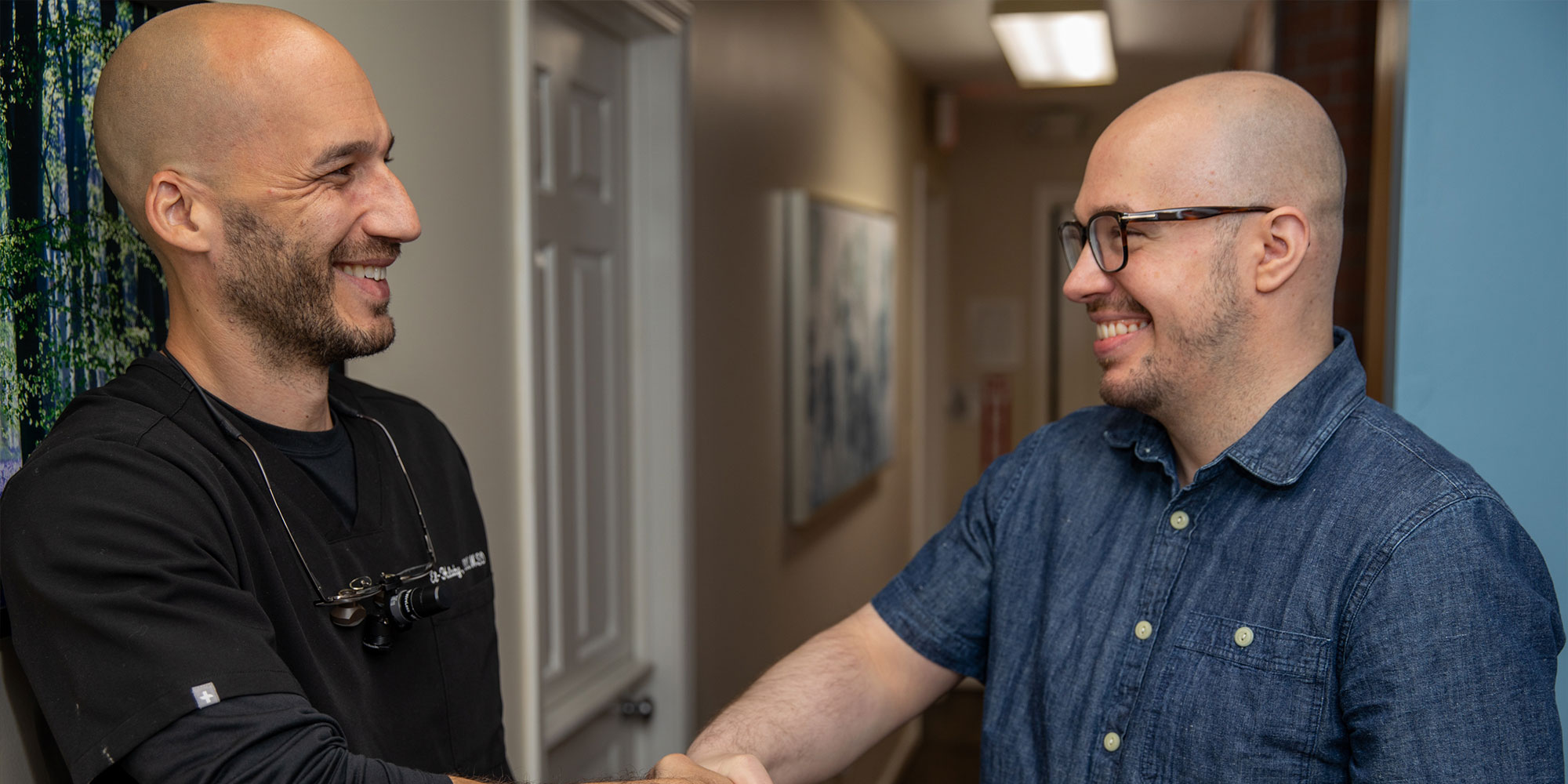 patient and doctor shaking hands after dental procedure