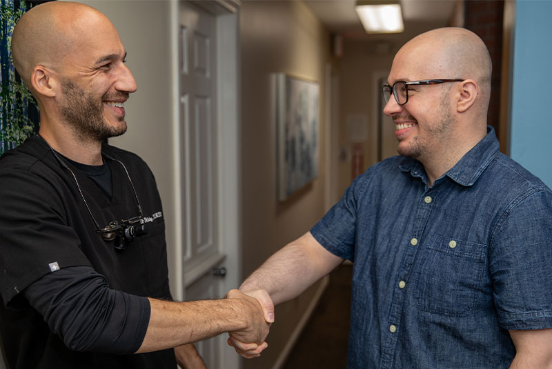patient and doctor shaking hands after dental procedure