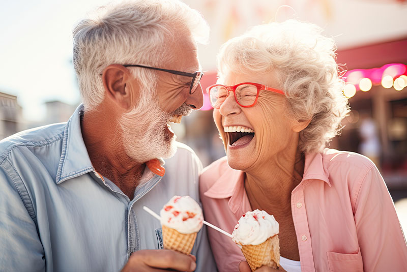 couple smiling while enjoying eating ice cream