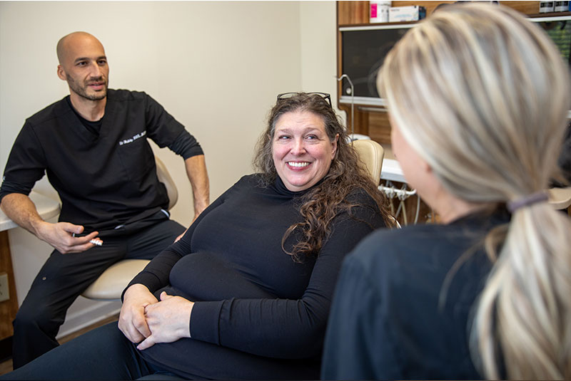 patient and staff member going over dental procedure information