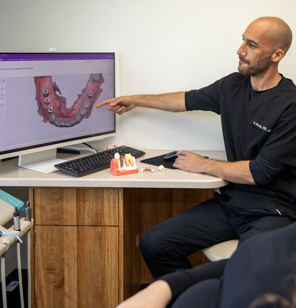 doctor showing patient dental procedure information
